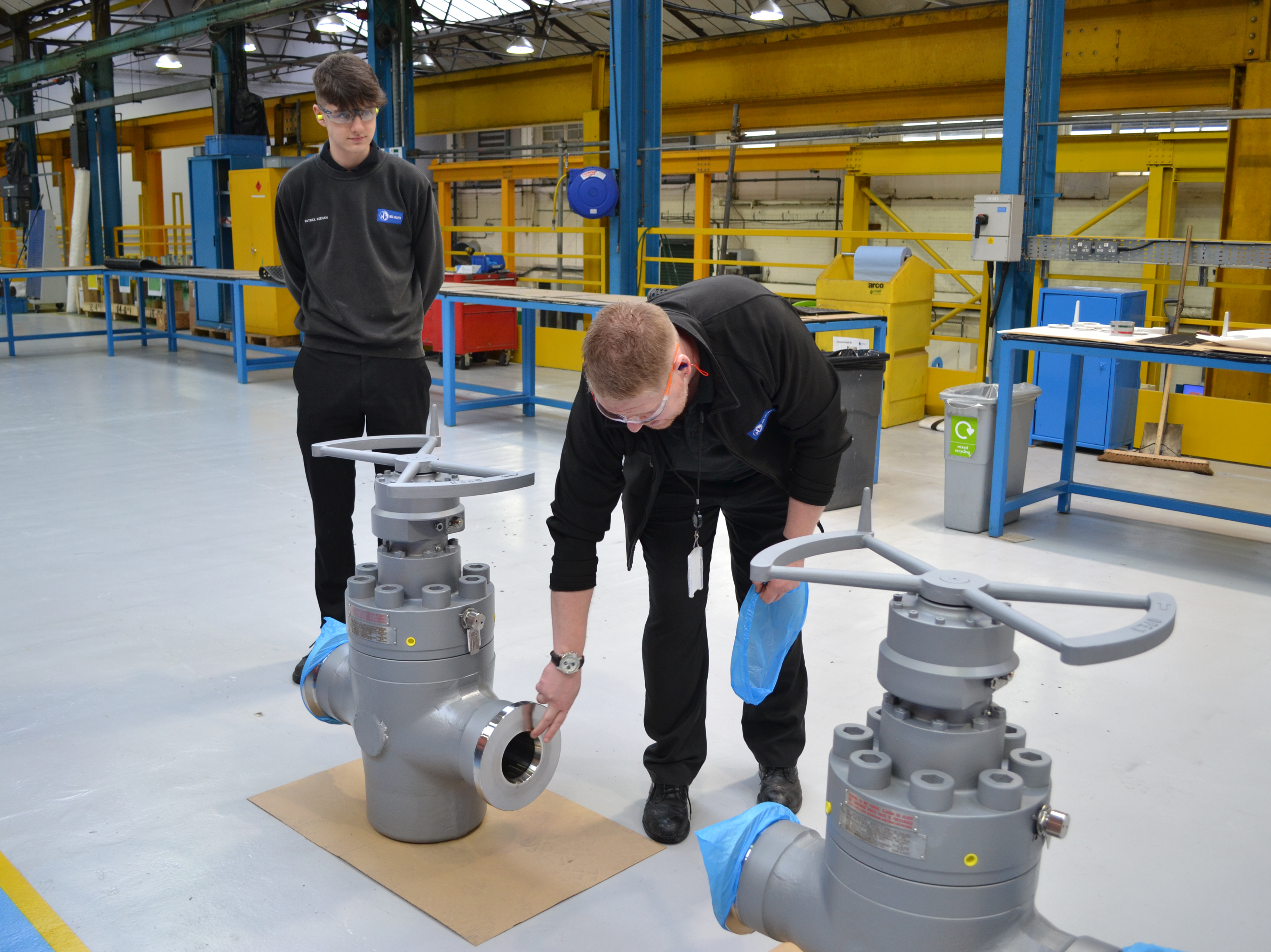 Employees at BEL Valves Newcastle with valves on factory floor